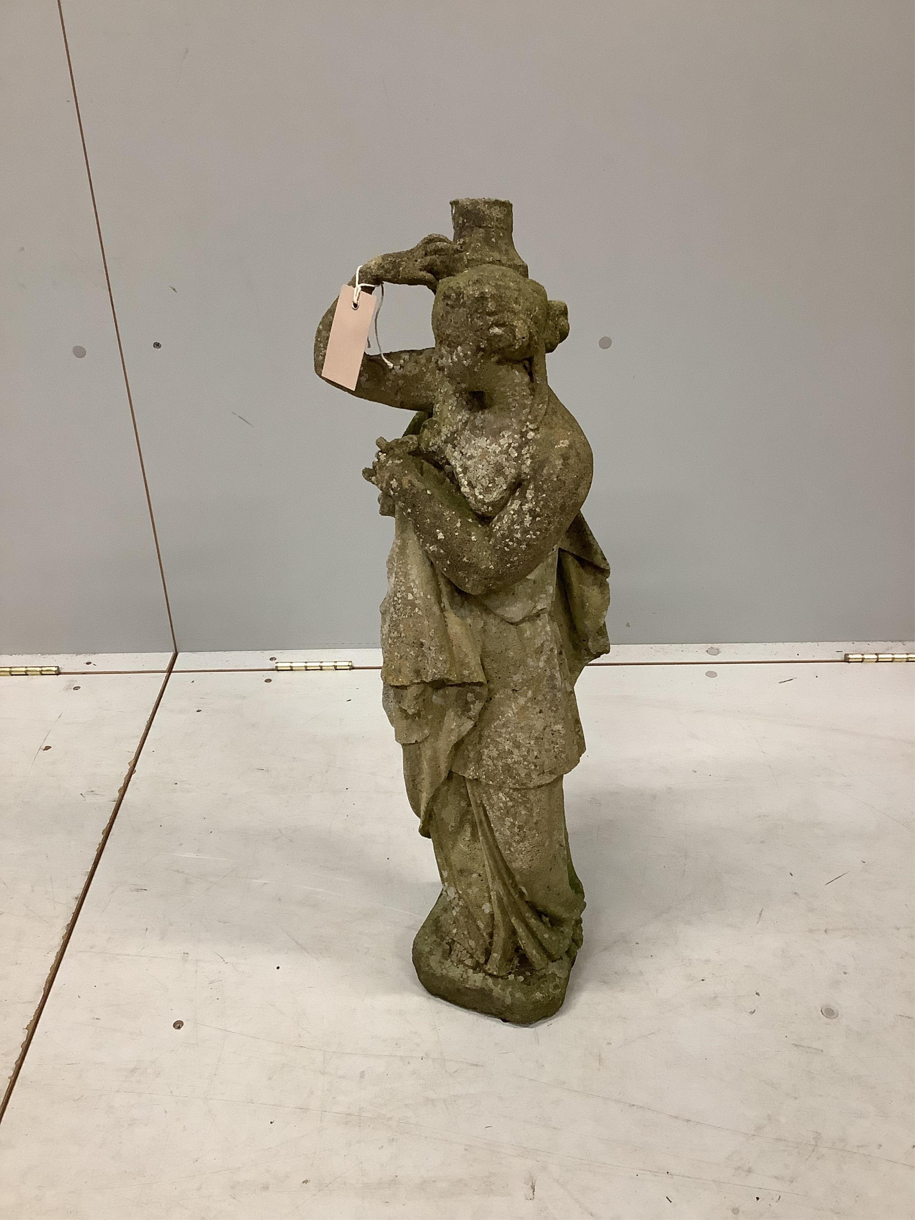 A reconstituted stone garden figure of a female water carrier, height 73cm. Condition - heavily weathered.